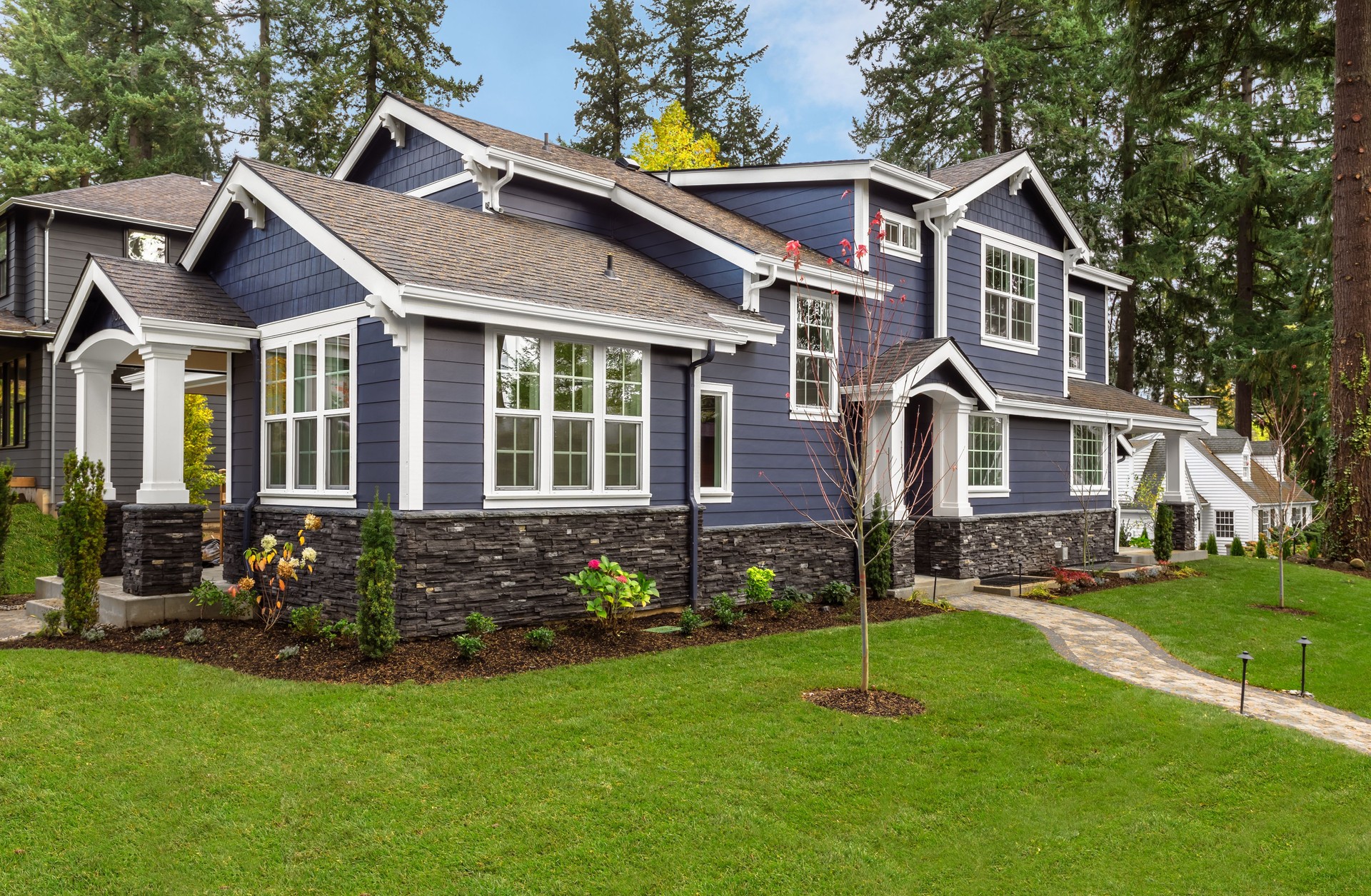 Beautiful Luxury Home Exterior with Green Grass and Landscaped yard